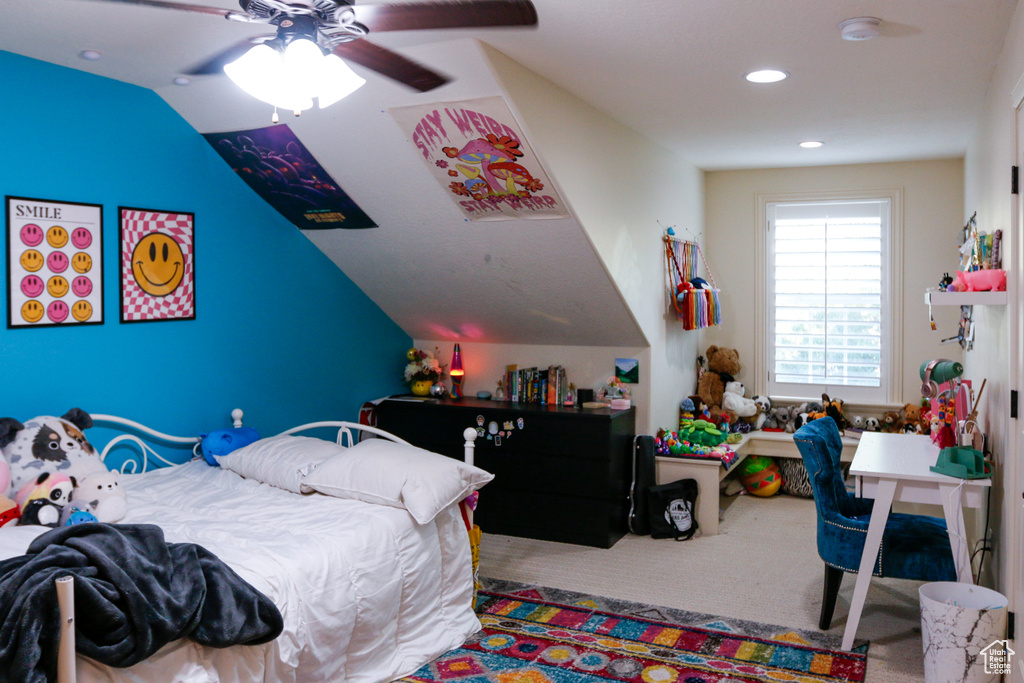 Carpeted bedroom featuring lofted ceiling and ceiling fan