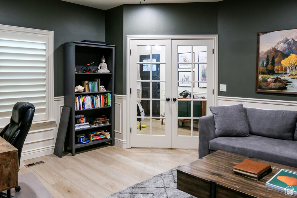 Home office featuring french doors and light wood-type flooring