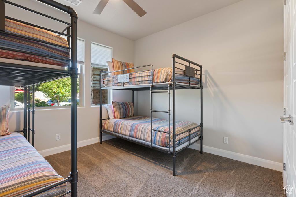 Carpeted bedroom with ceiling fan