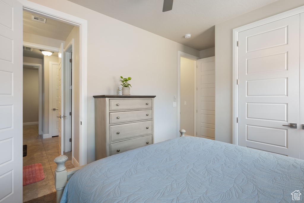 Tiled bedroom with ceiling fan