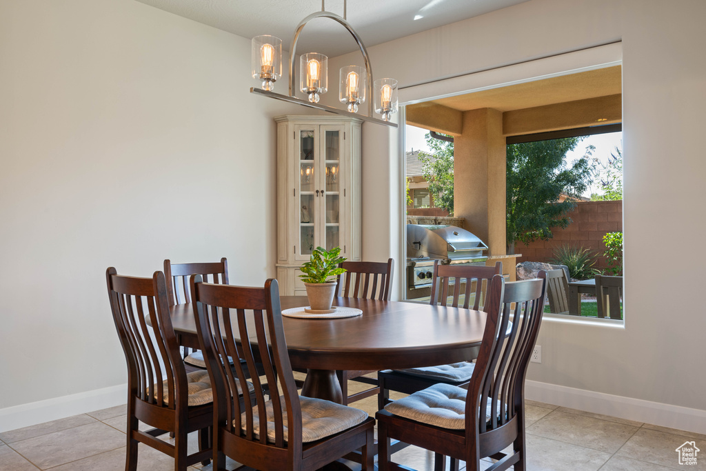 Dining space featuring a notable chandelier and light tile patterned floors