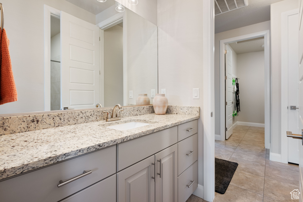 Bathroom featuring tile patterned flooring and vanity