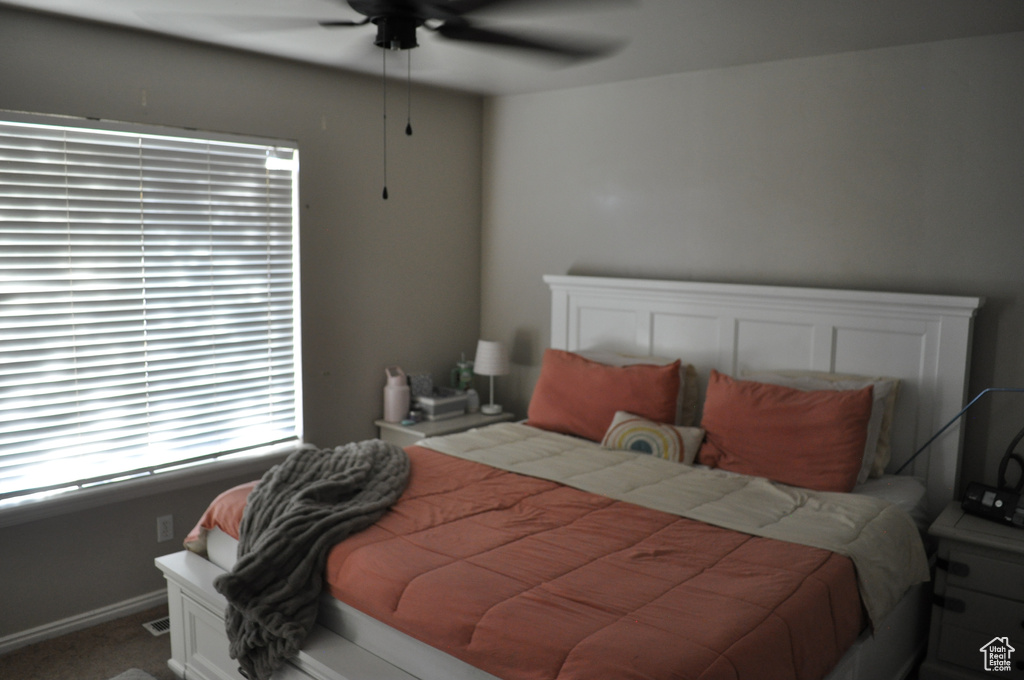 Bedroom with ceiling fan and carpet flooring