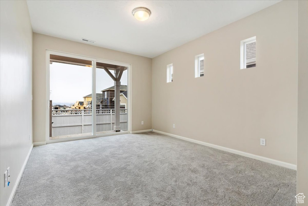 Spare room featuring carpet floors and plenty of natural light