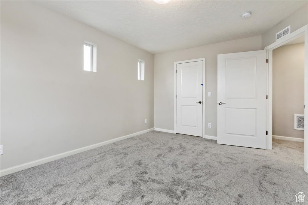 Unfurnished bedroom featuring a closet and carpet