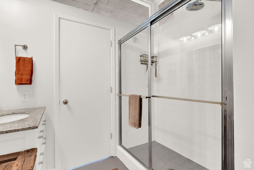 Bathroom featuring an enclosed shower and vanity