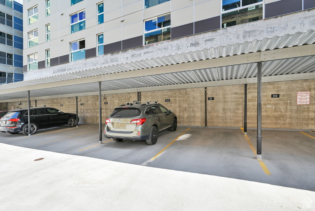 View of parking / parking lot featuring a carport