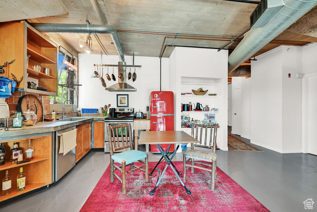 Interior space featuring stainless steel appliances, sink, and concrete floors