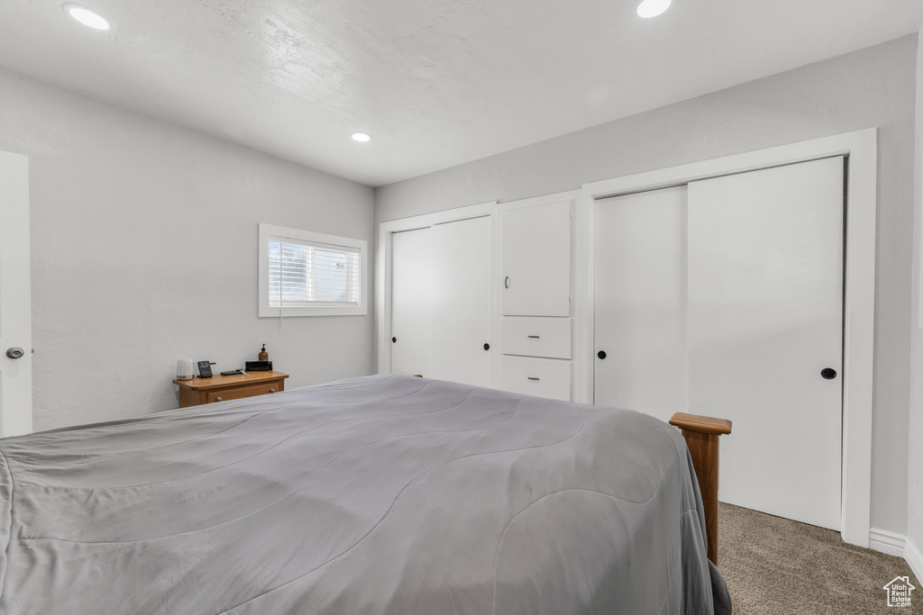 Bedroom with carpet floors and two closets