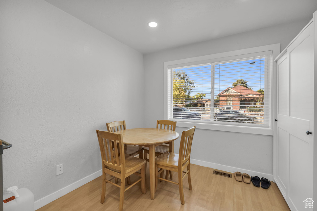 Dining area with light hardwood / wood-style floors