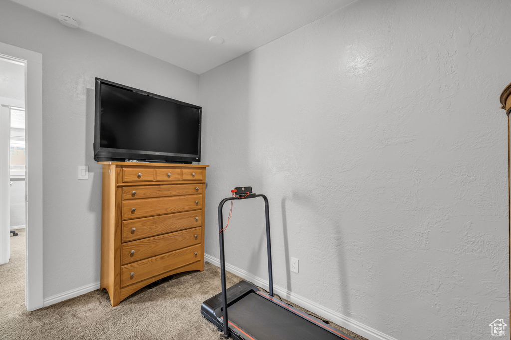 Workout room with a textured ceiling and carpet flooring