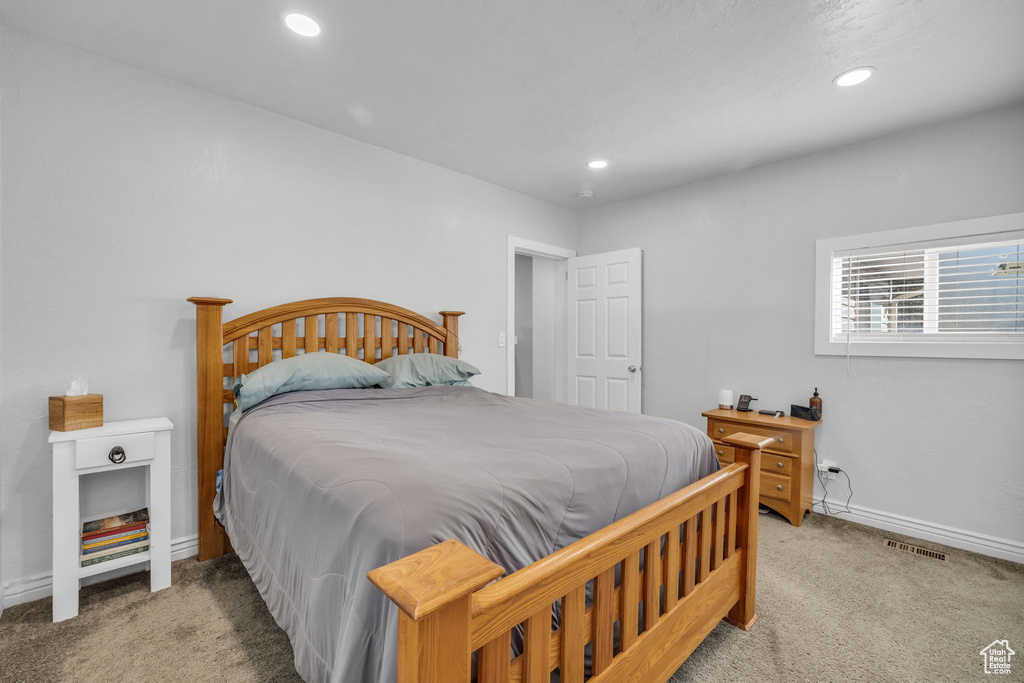 Bedroom with light carpet