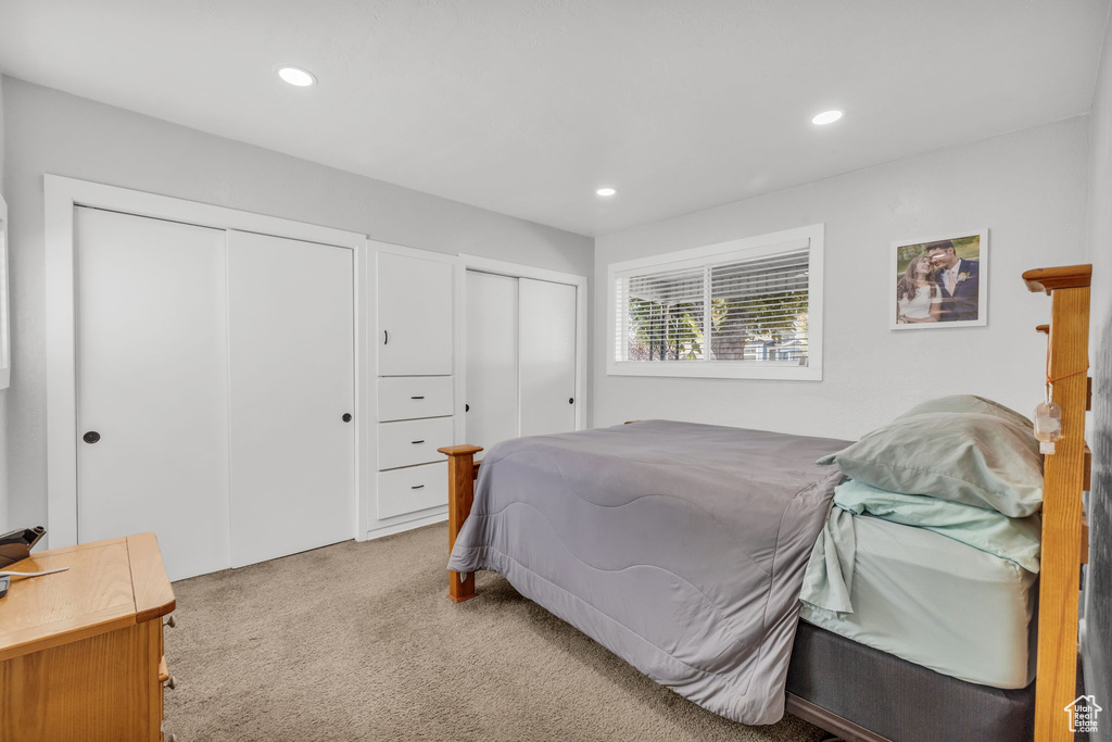 Carpeted bedroom featuring two closets