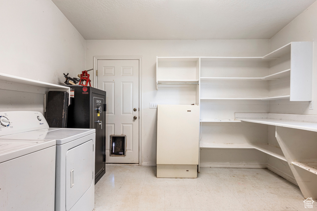 Washroom featuring washing machine and dryer