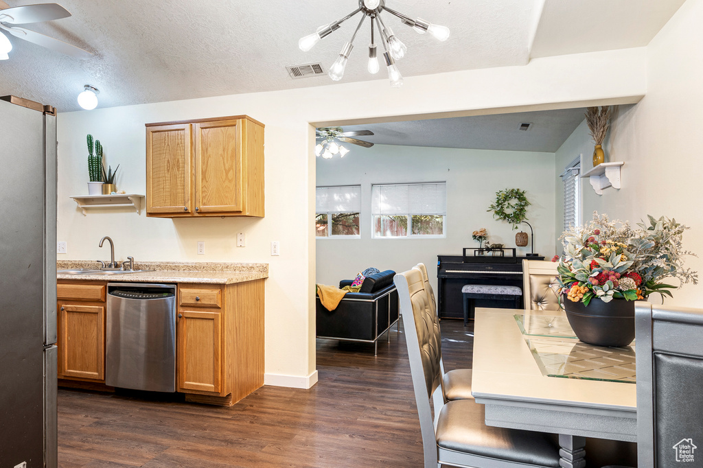 Kitchen with lofted ceiling, dark wood-type flooring, sink, and stainless steel appliances