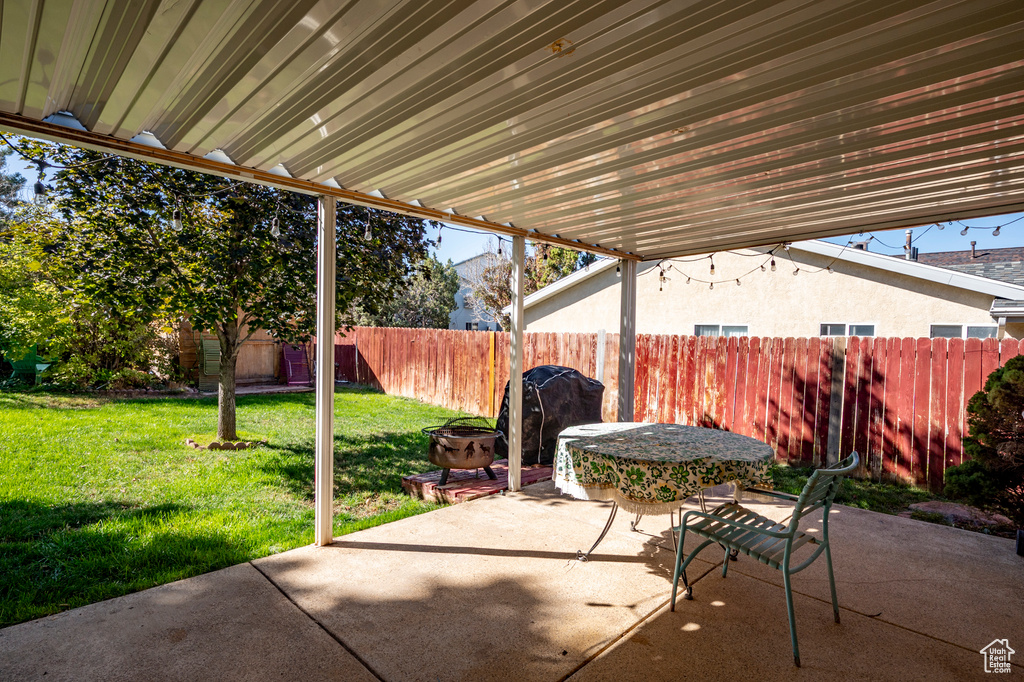 View of patio featuring a grill