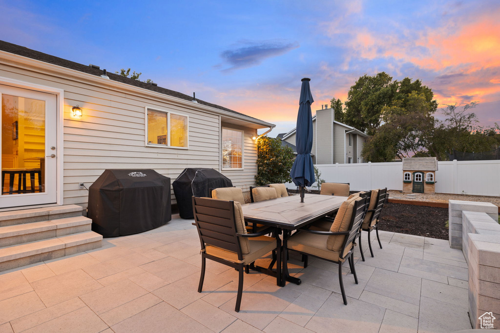 Patio terrace at dusk with area for grilling