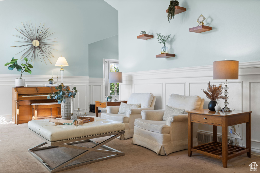 Living room featuring high vaulted ceiling and carpet floors