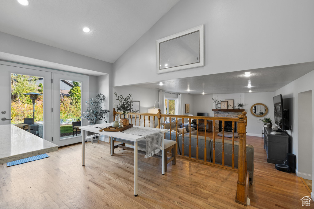 Dining area featuring light hardwood / wood-style floors and high vaulted ceiling