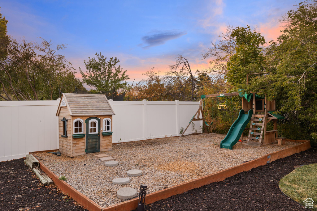 Playground at dusk featuring a storage unit