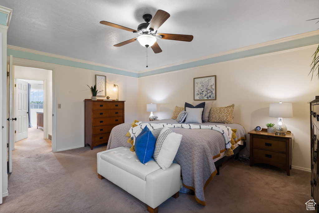 Bedroom with ceiling fan, light colored carpet, and ornamental molding