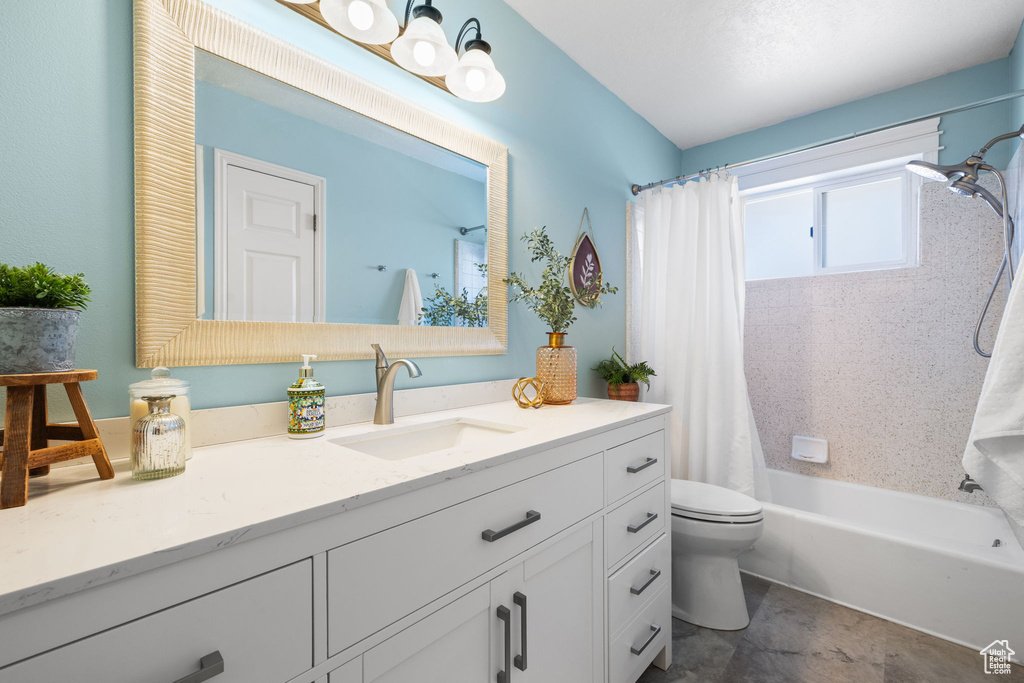 Full bathroom with vanity, toilet, and shower / bathtub combination with curtain