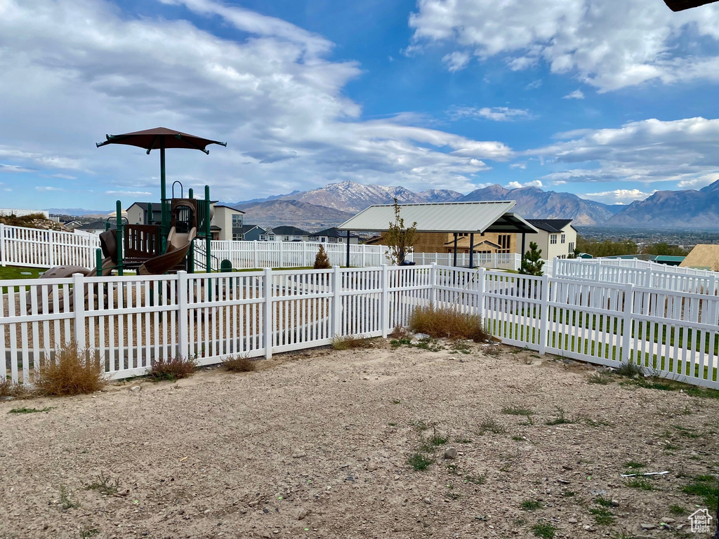 View of yard with a playground and a mountain view