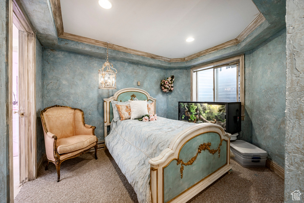 Carpeted bedroom featuring crown molding, recessed lighting, and a notable chandelier