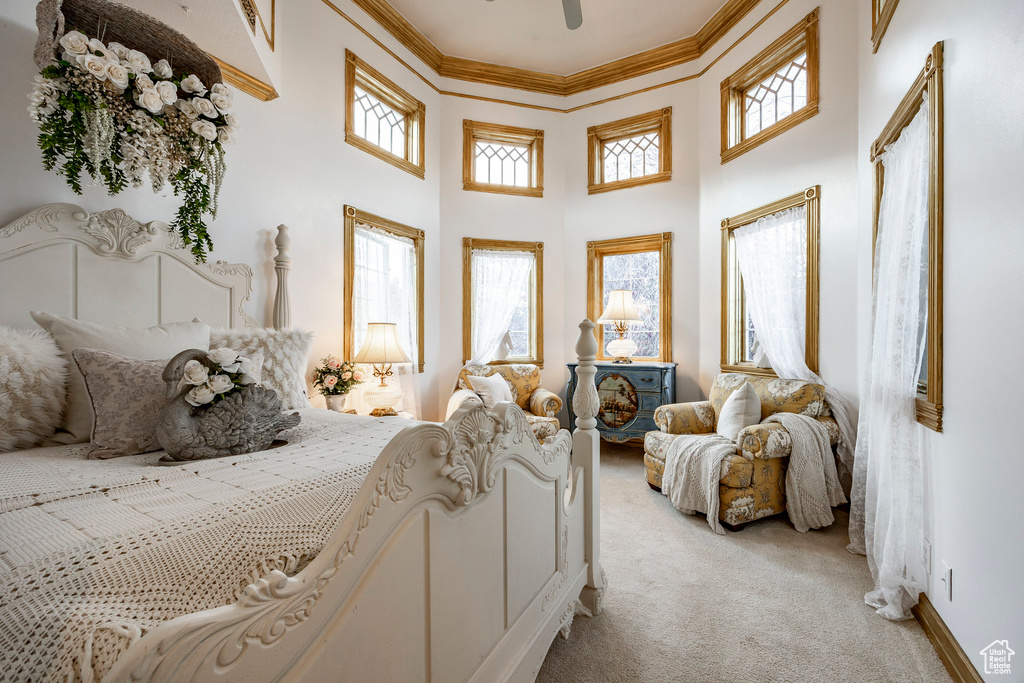 Bedroom featuring crown molding, a high ceiling, and light carpet