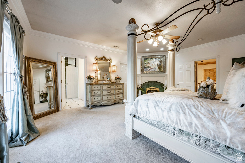 Carpeted bedroom featuring ornate columns and ornamental molding