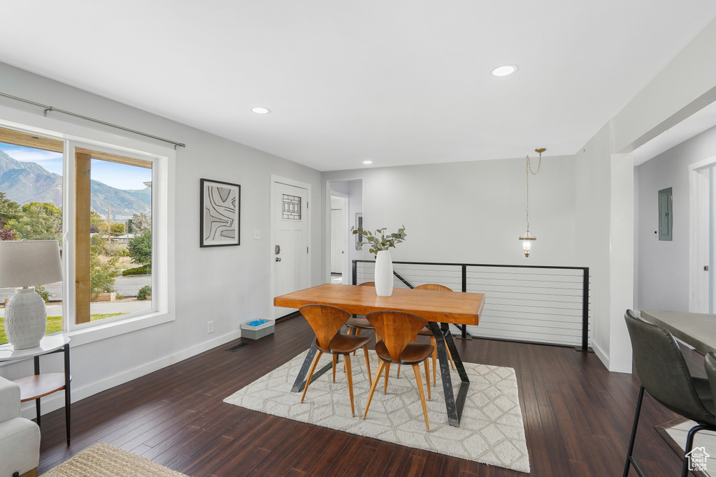 Dining room with a mountain view, electric panel, and dark hardwood / wood-style flooring