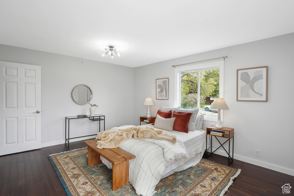 Bedroom with dark hardwood / wood-style floors