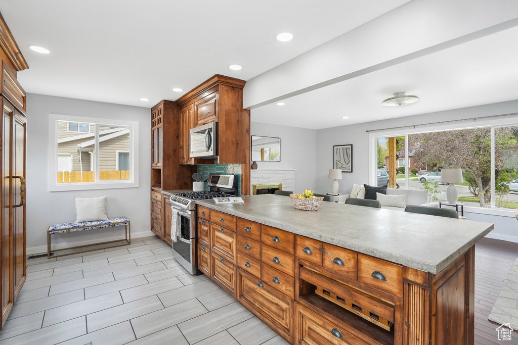 Kitchen with decorative backsplash and appliances with stainless steel finishes