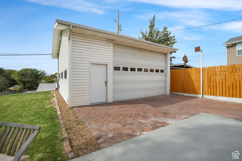 Garage featuring wood walls and a yard