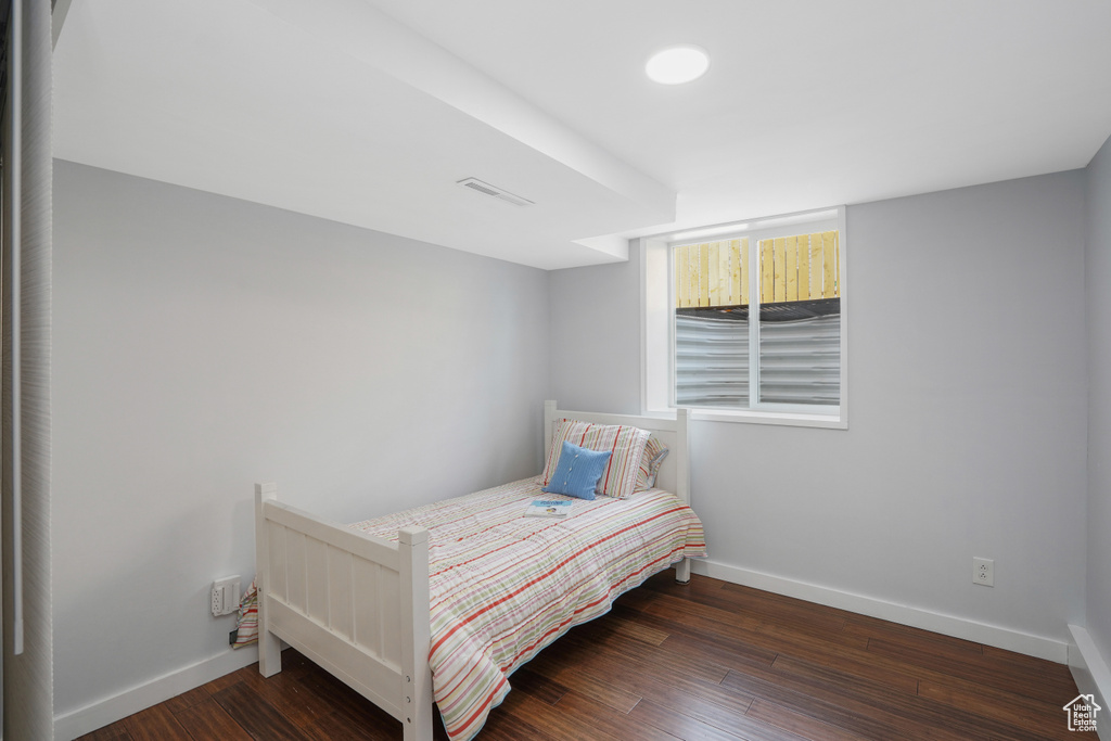 Bedroom with dark wood-type flooring