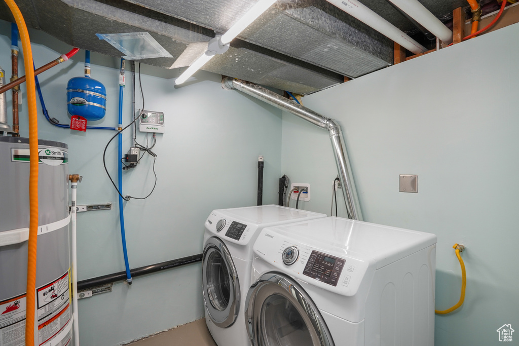 Laundry area featuring separate washer and dryer and gas water heater