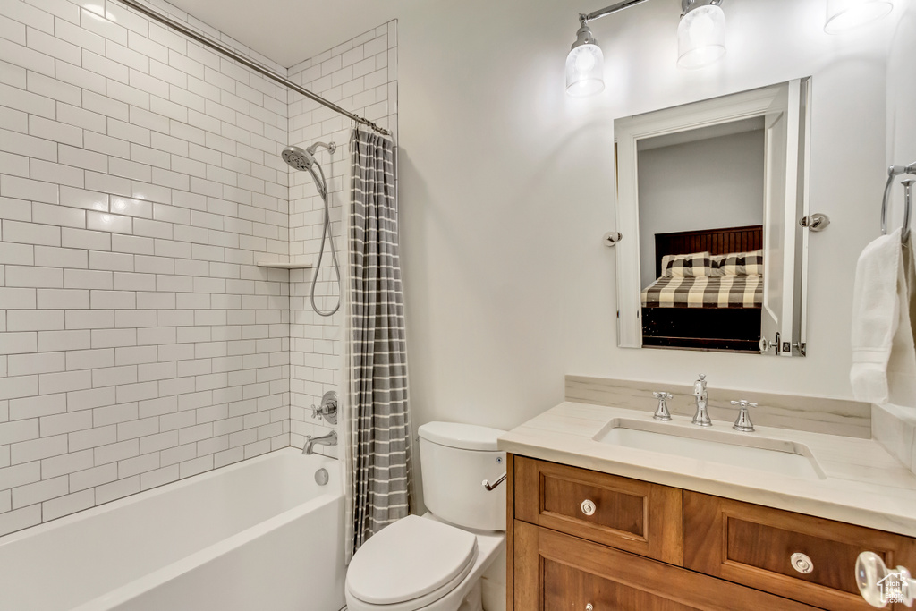 Full bathroom with vanity, toilet, and shower / bath combo