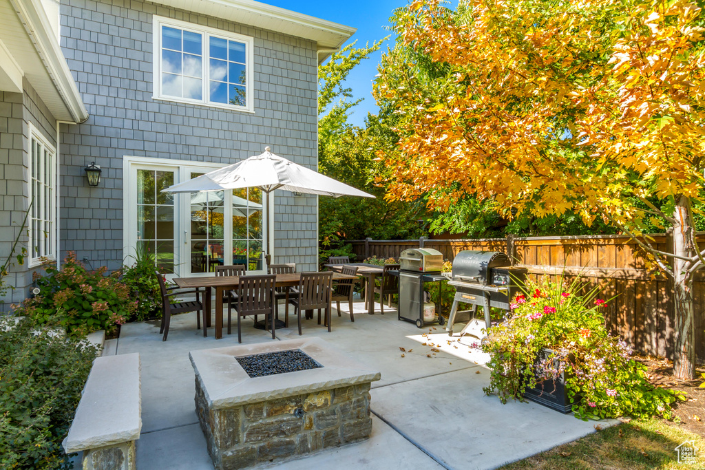 View of patio with an outdoor fire pit