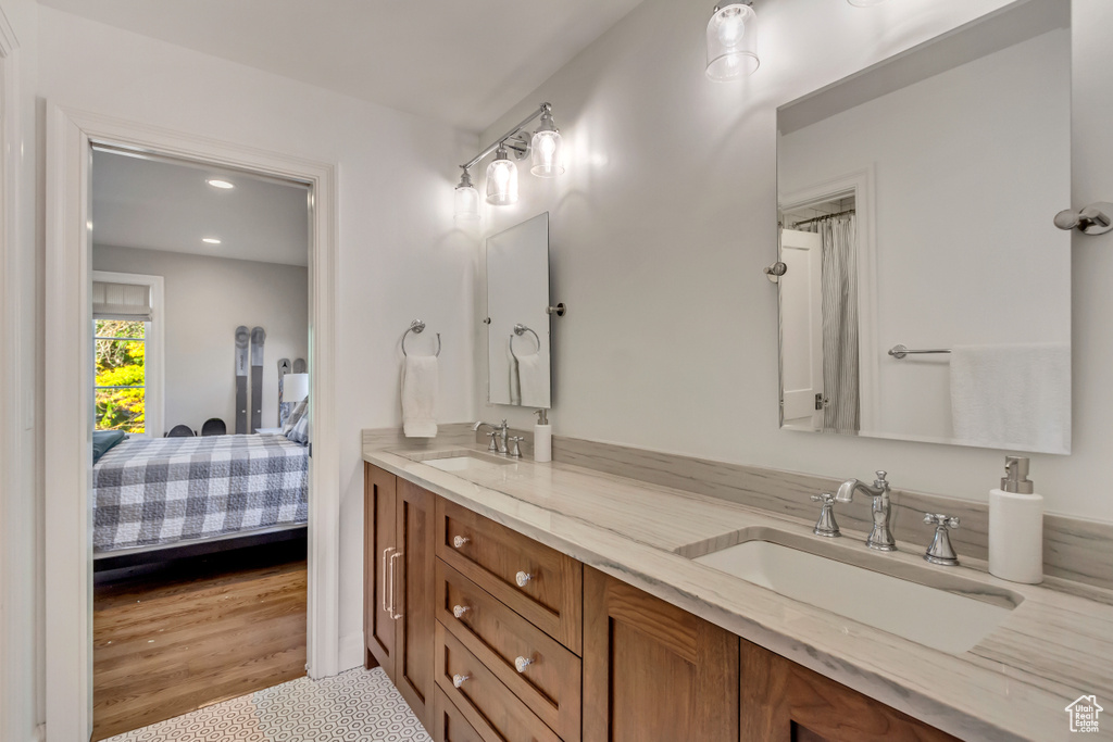 Bathroom with hardwood / wood-style flooring and vanity