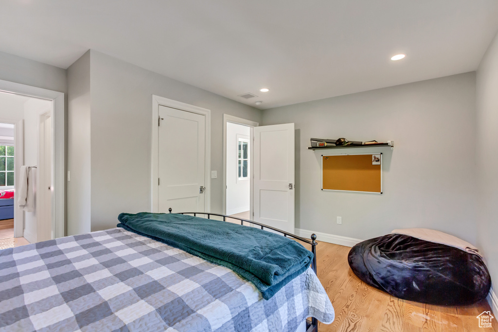 Bedroom with hardwood / wood-style flooring