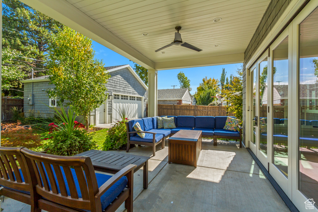 View of patio featuring ceiling fan, an outdoor hangout area, and an outdoor structure