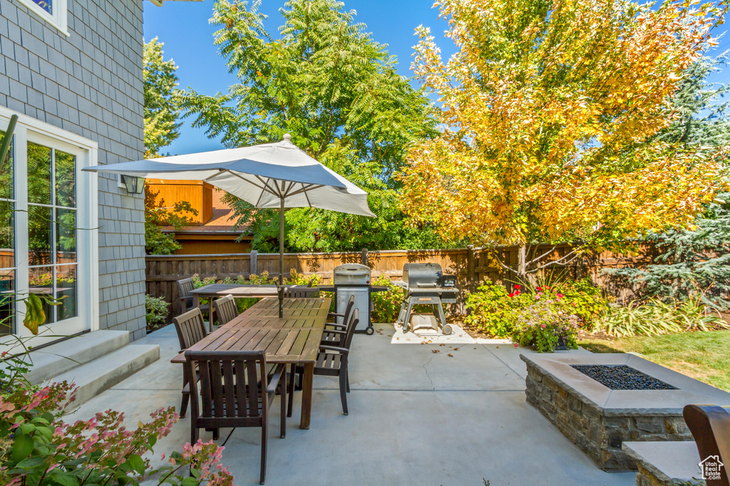 View of patio / terrace featuring a grill and an outdoor fire pit