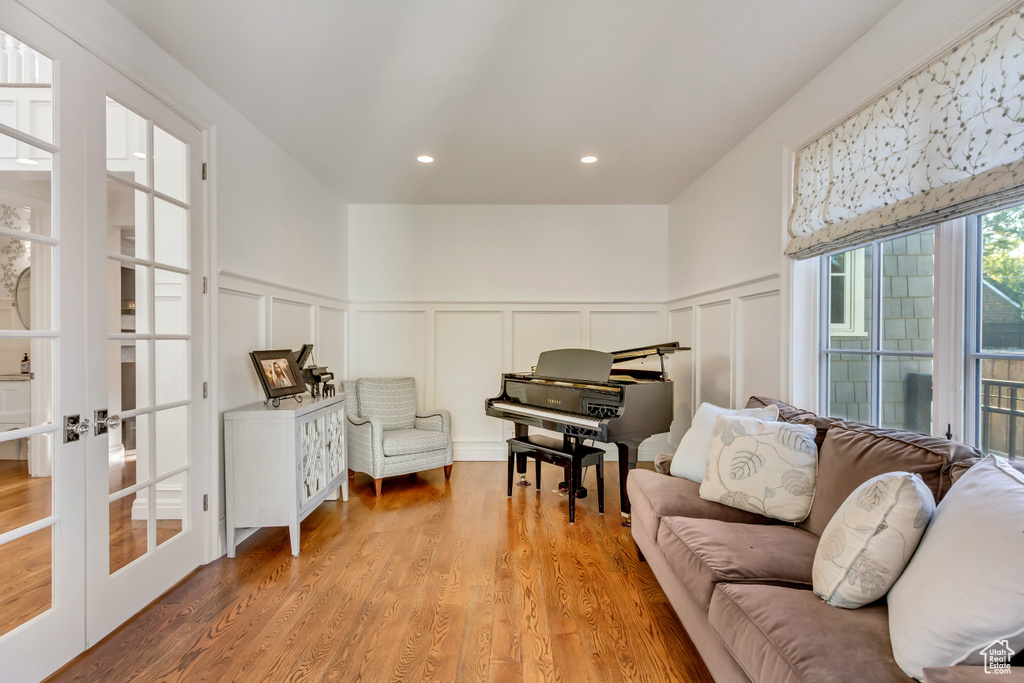 Sitting room featuring french doors and light wood-type flooring