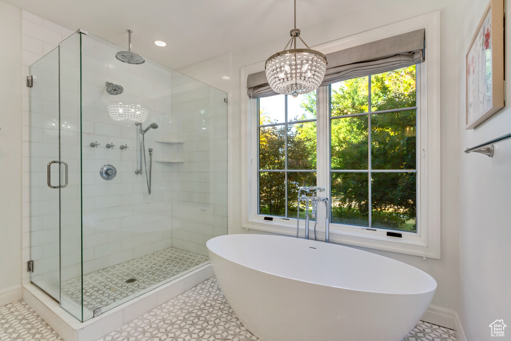 Bathroom with separate shower and tub, tile patterned floors, and a healthy amount of sunlight