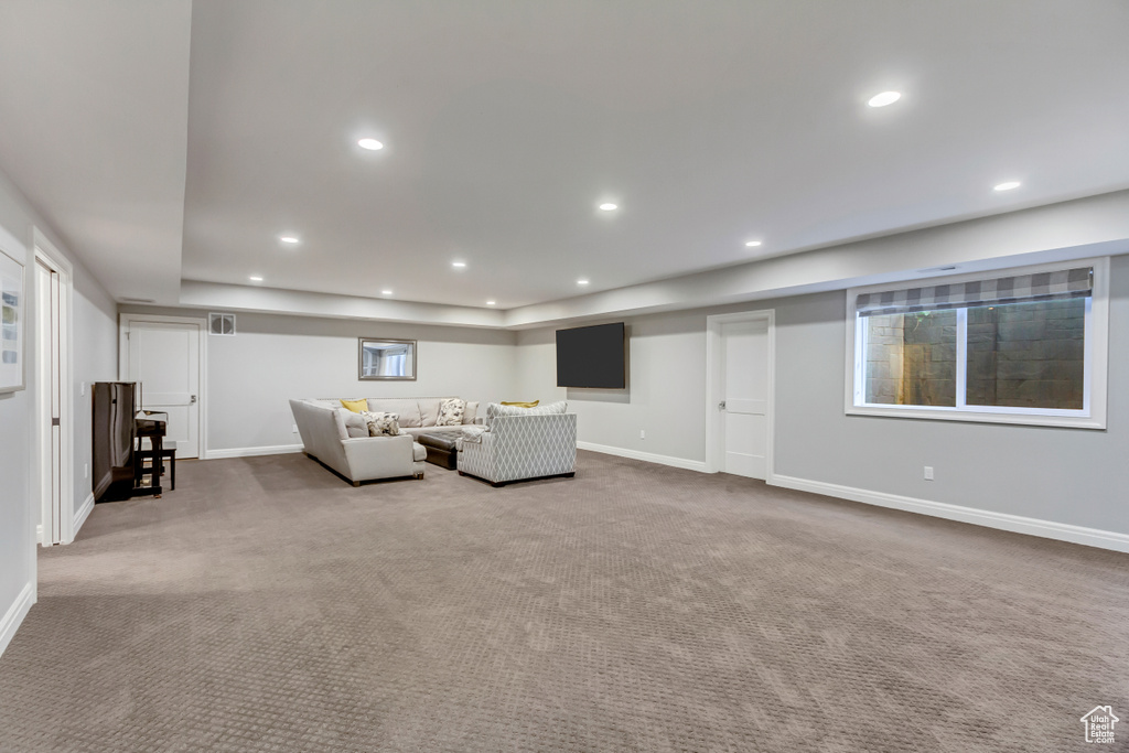 Unfurnished living room featuring light carpet