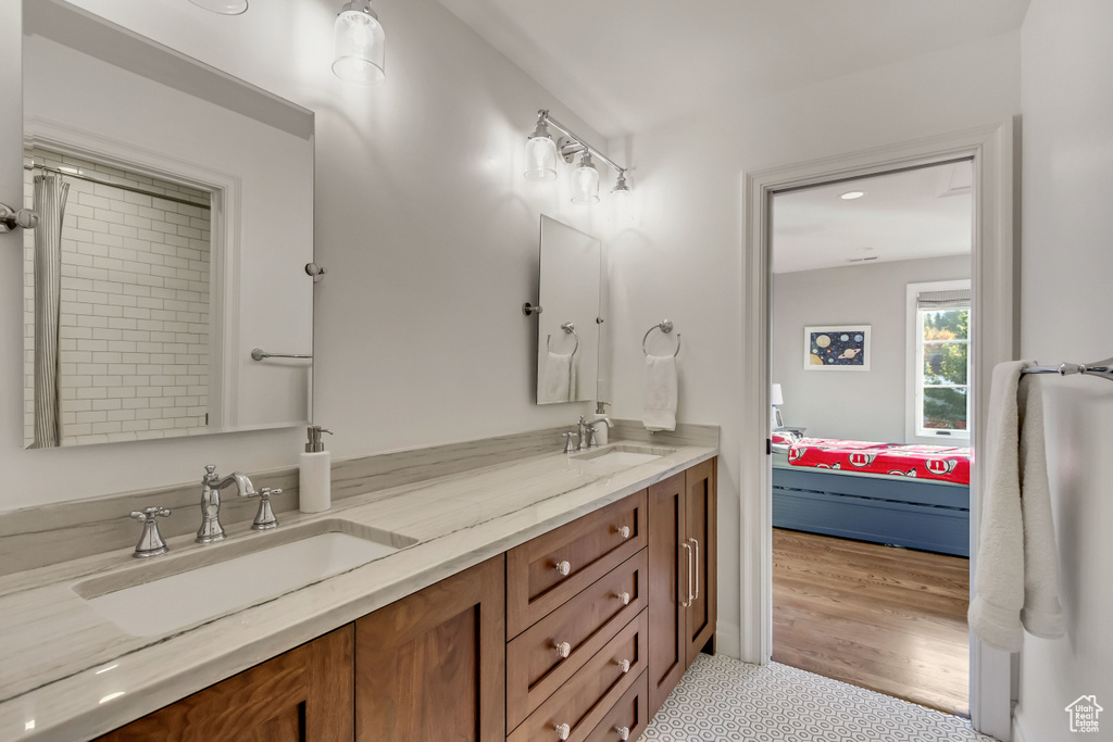 Bathroom featuring vanity and wood-type flooring