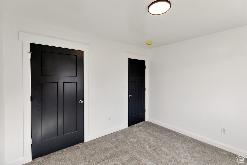 Unfurnished bedroom featuring light carpet