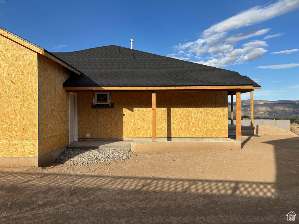 Back of property with a patio and a mountain view