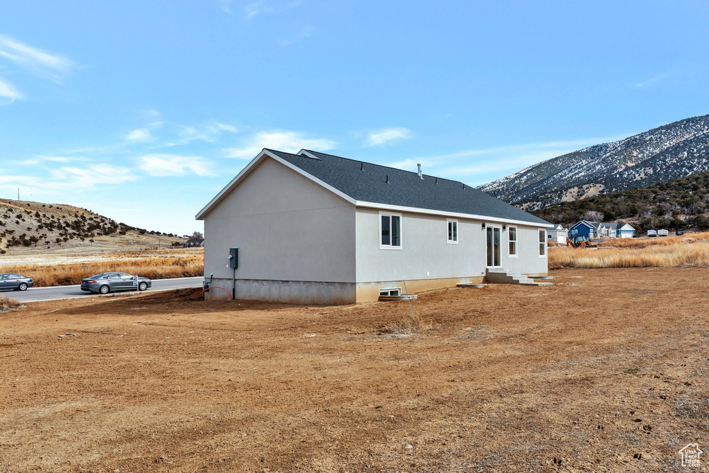 Back of property with a mountain view