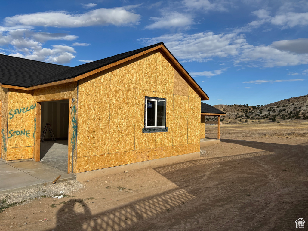 View of side of property with a patio and a mountain view